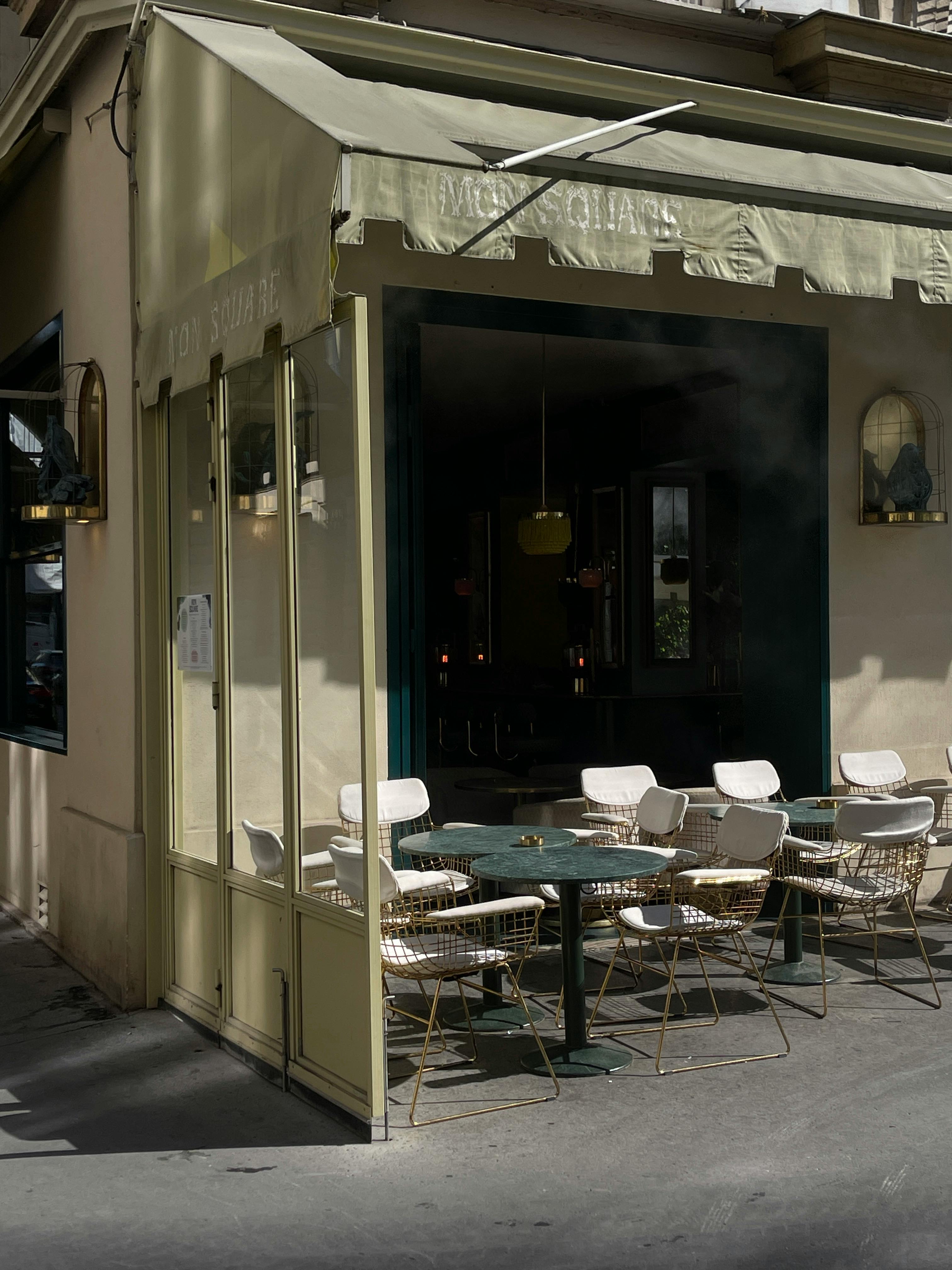 Stylish outdoor bistro setup at an urban café with inviting seating arrangements.