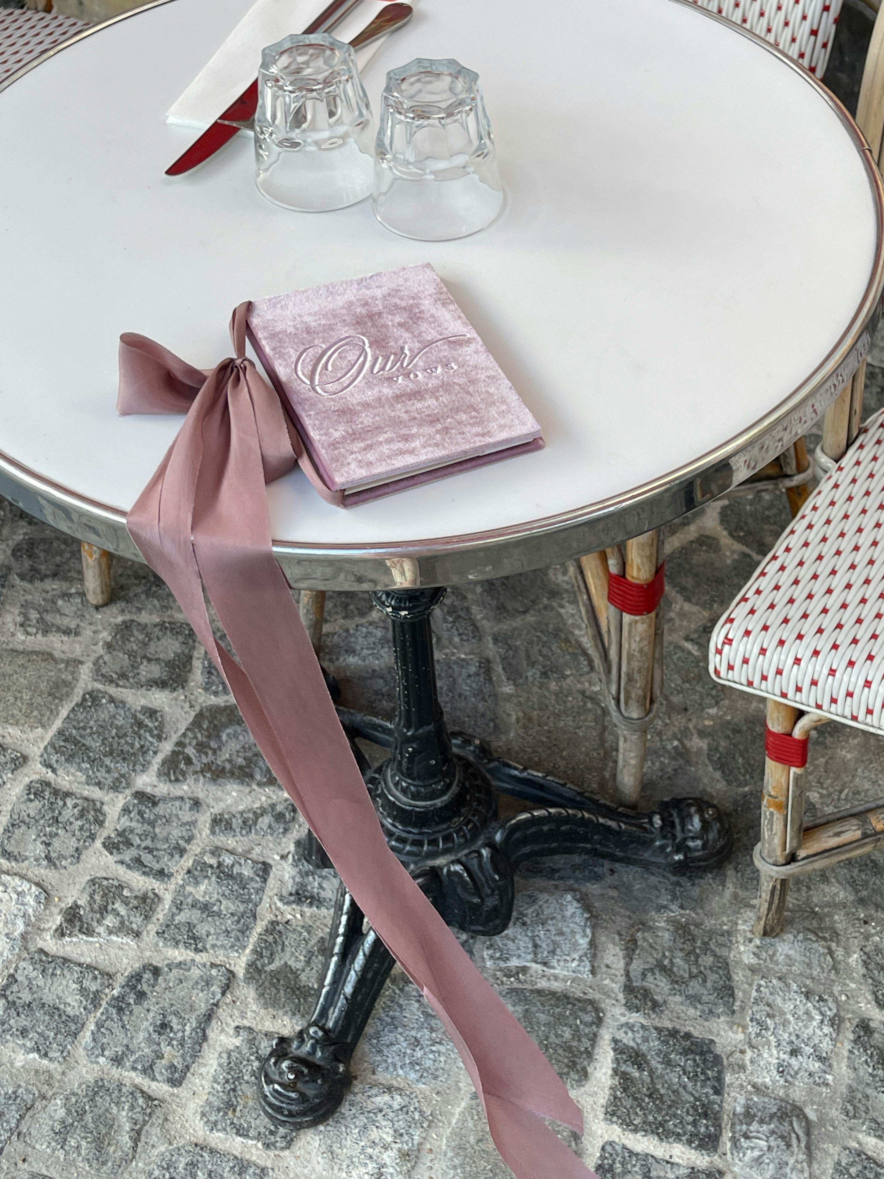 Charming outdoor cafe scene with a vintage vibe and elegant ribbon decor.