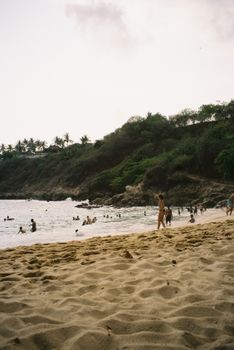 Sun-soaked beach scene at Playa Carrizalillo, Oaxaca, highlighting leisure and natural beauty.