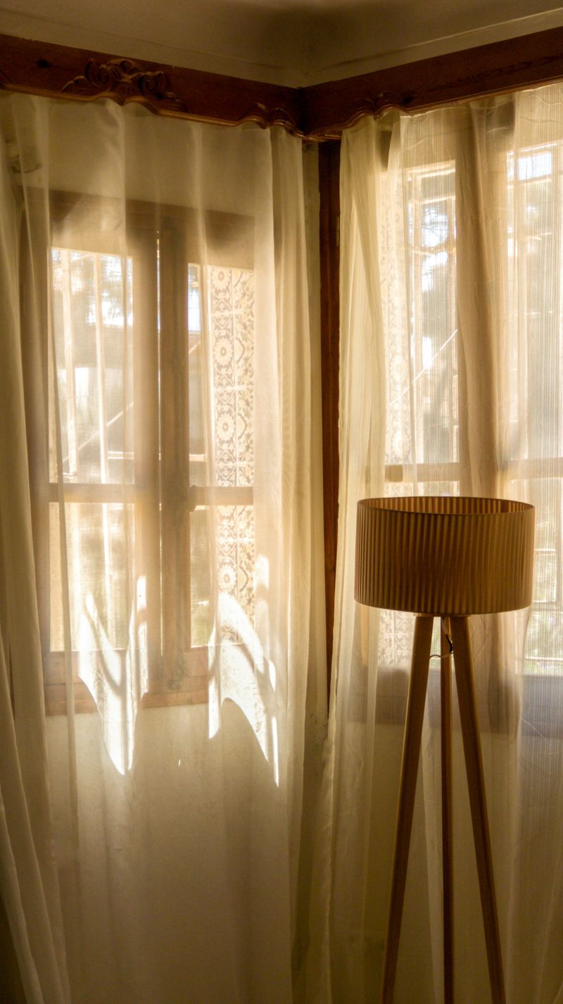 Lamp and sheer curtain in a warm study
