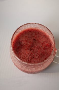 Top view of a fresh berry smoothie in a glass cup, perfect for a healthy summer refreshment.