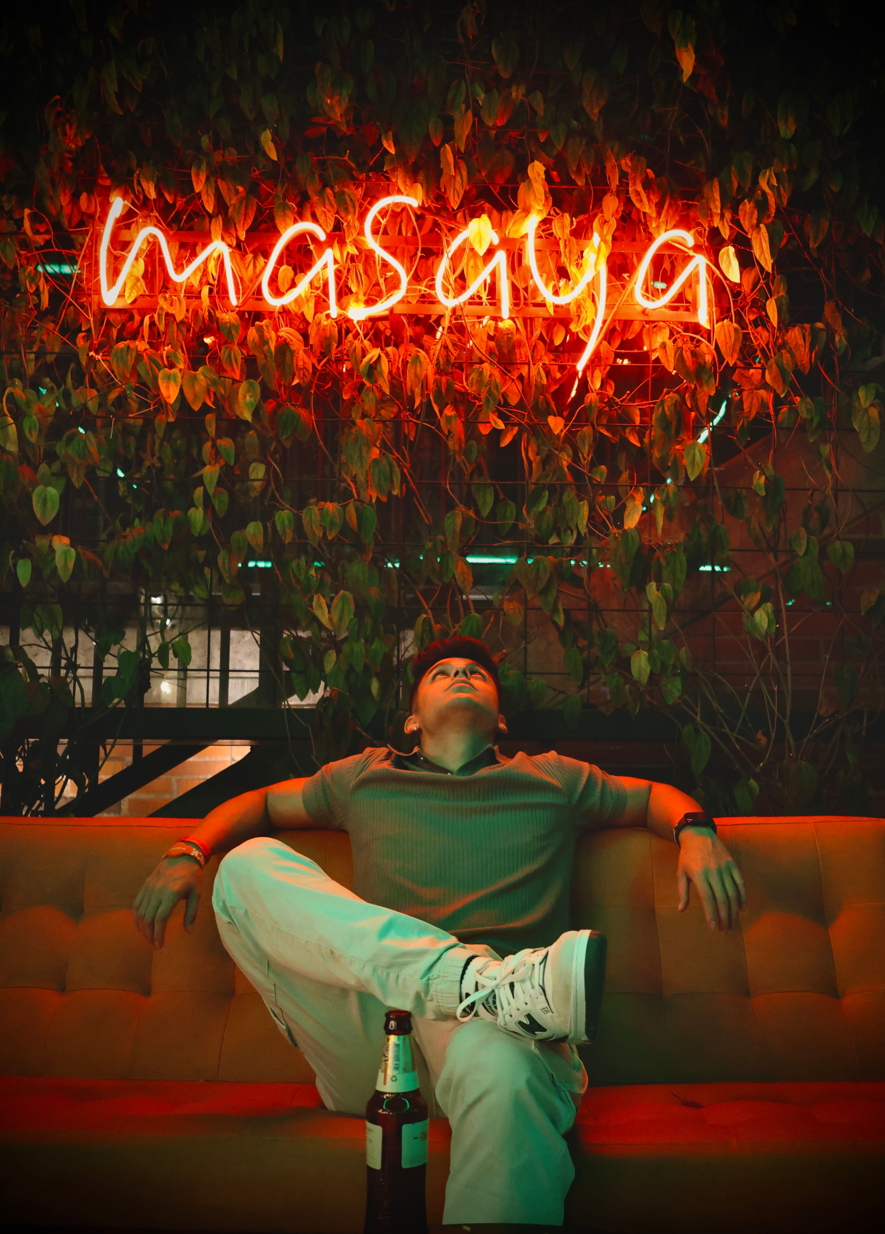 Casual nightlife scene at Masaya Hostel in Medellín with neon lights and relaxed ambiance.