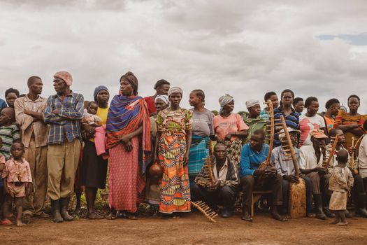 A vibrant group of people in traditional attire gathered outdoors in Masindi, Uganda.