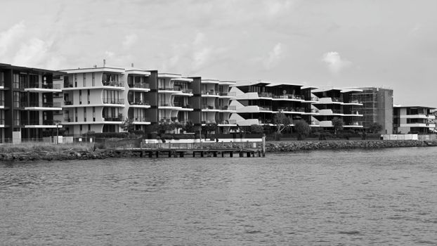Black and white photo of modern waterfront apartments in Brisbane, Australia.