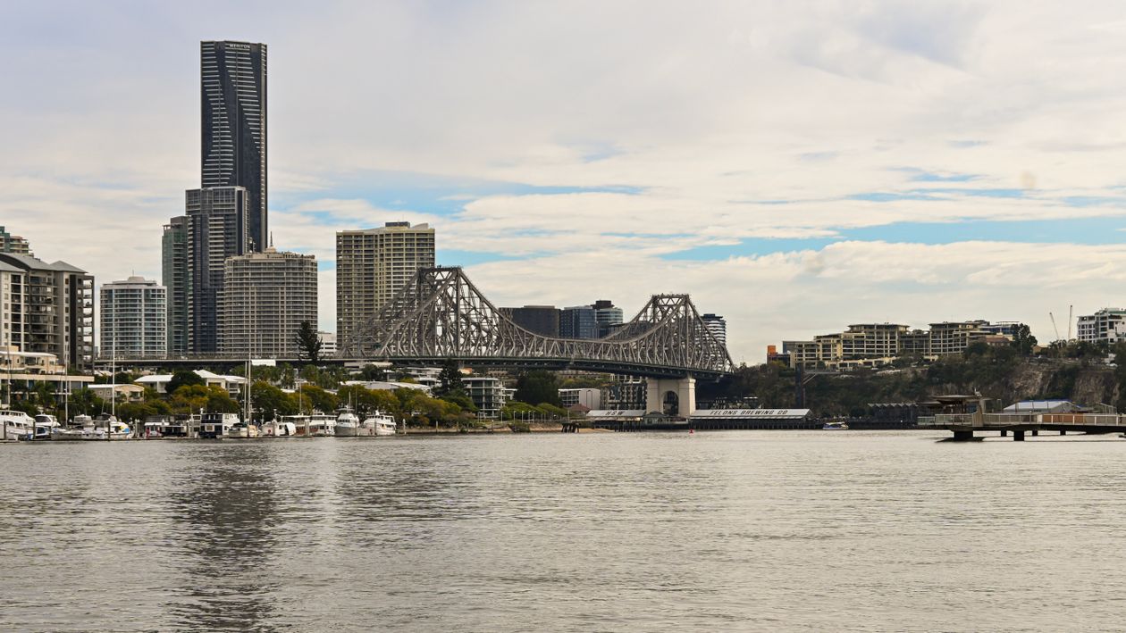A view of a city skyline with a bridge in the background · Free Stock Photo