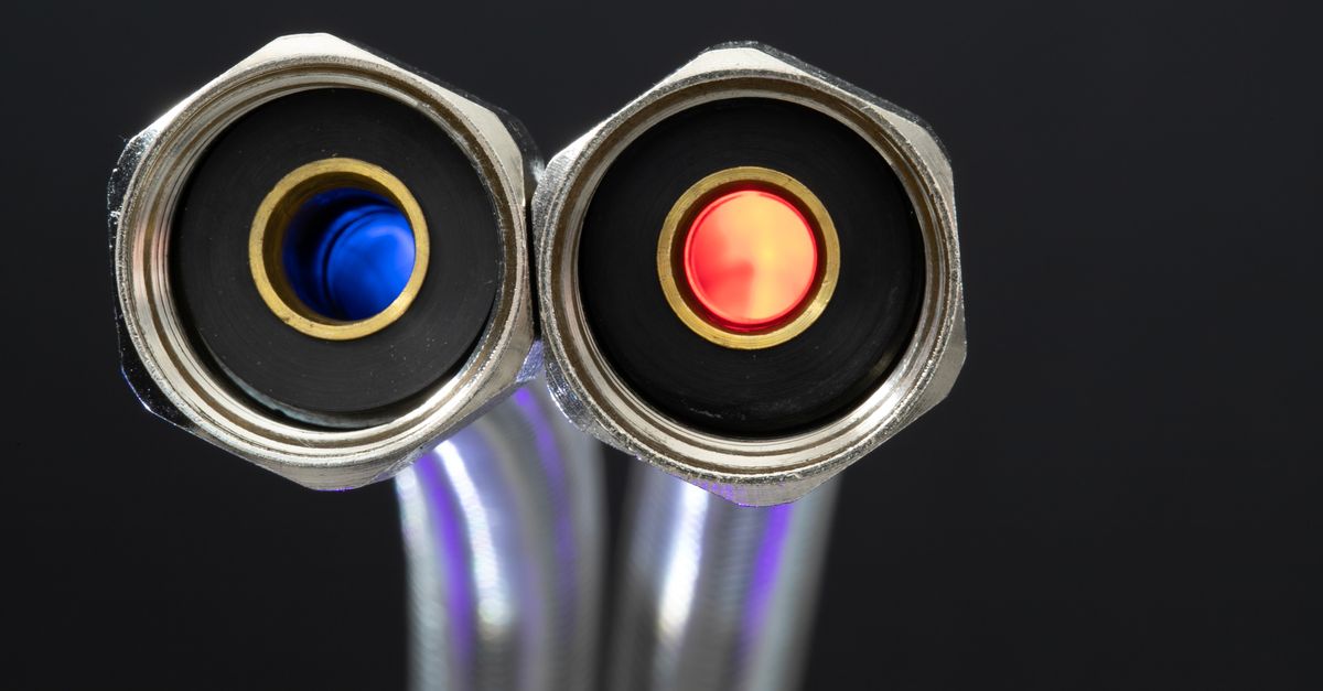 Detailed close-up of chrome metal hose connectors with red and blue color indicators.