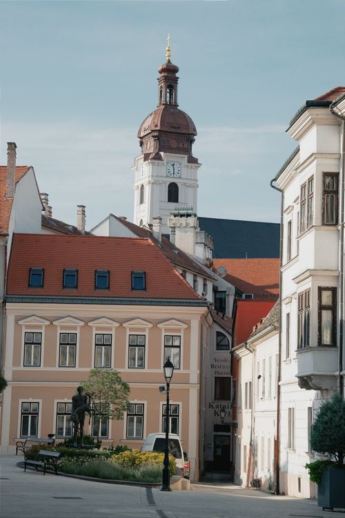 Free Charming urban scene with historic architecture and church tower in Sopron, Hungary. Stock Photo