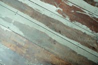 A close up of a wooden floor with peeling paint