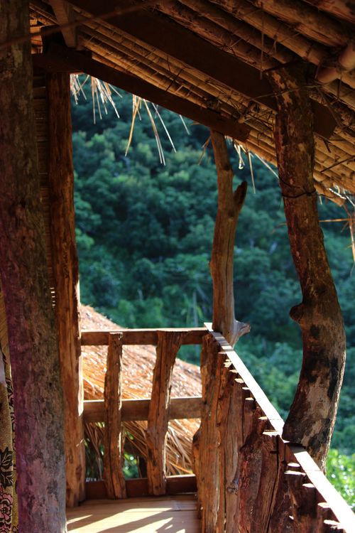 Free A charming rustic wooden porch with a view of the lush forest, perfect for nature lovers. Stock Photo