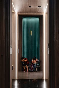 Hotel front desk with a sign that says check-in, illustrating the hotel check-in procedure