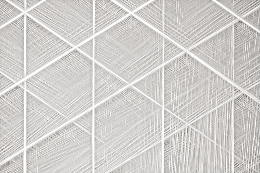 Complex geometric design featuring white intersecting lines and sharp angles.