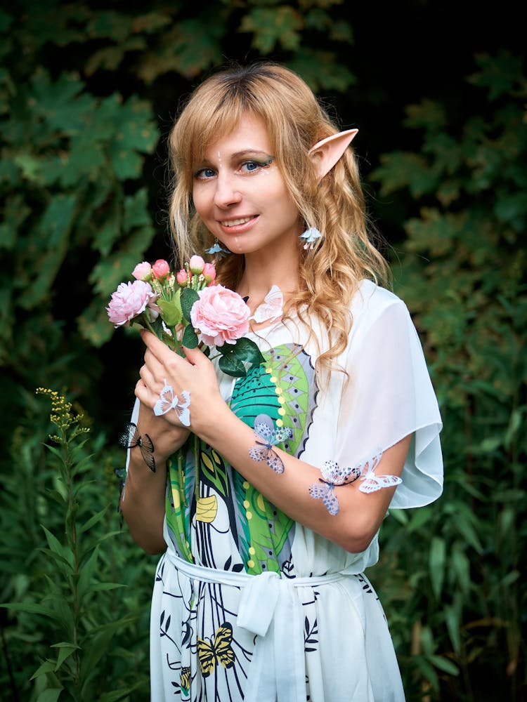 Photo Of Woman Holding Flowers