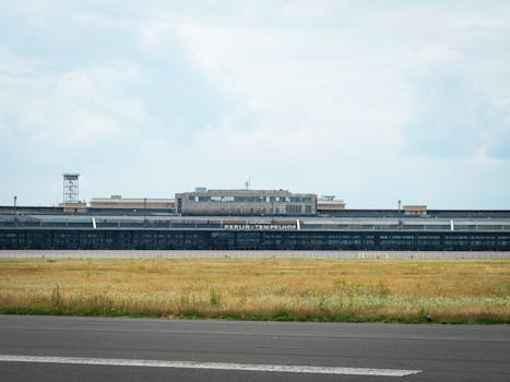 View of Berlin Tempelhof Airport, showcasing its iconic architecture and open field.