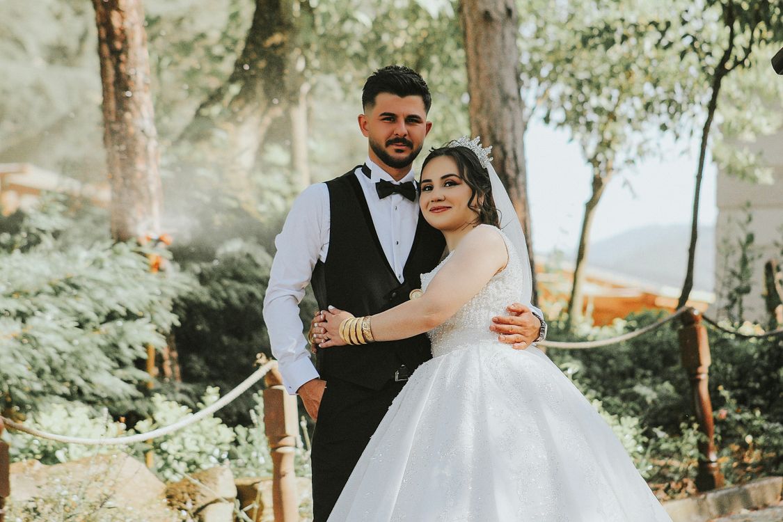 The Bride and Groom Embracing in a Park · Free Stock Photo