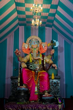 A vibrant statue of Lord Ganesha adorned in a traditional setup for Ganesh Chaturthi festival in Mumbai, India.