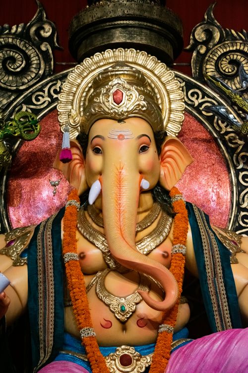 Free Ornate Ganesha statue showcasing traditional Indian arts and vibrant colors captured during Ganesh Chaturthi in Mumbai. Stock Photo