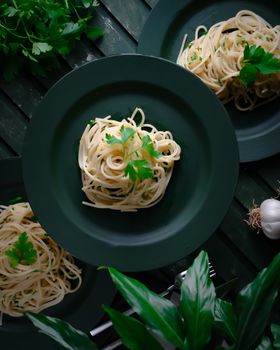 Delicious rustic spaghetti garnished with fresh parsley, perfect for a homemade meal.