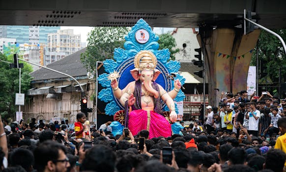 Crowds gather in Mumbai for Ganesh Chaturthi festival, celebrating with a grand parade.