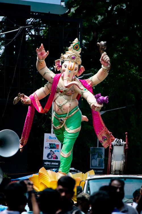 Free Colorful celebration of Ganesh Chaturthi in Mumbai, India with a grand parade and lively crowd. Stock Photo