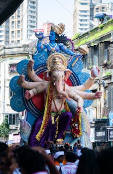 Vibrant Ganesh Chaturthi festival parade in Mumbai, featuring an ornate Ganesha idol.