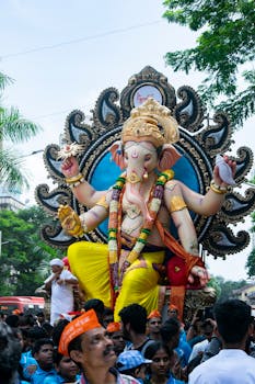 Vibrant Ganesh Chaturthi festival with a grand statue in Mumbai, India.