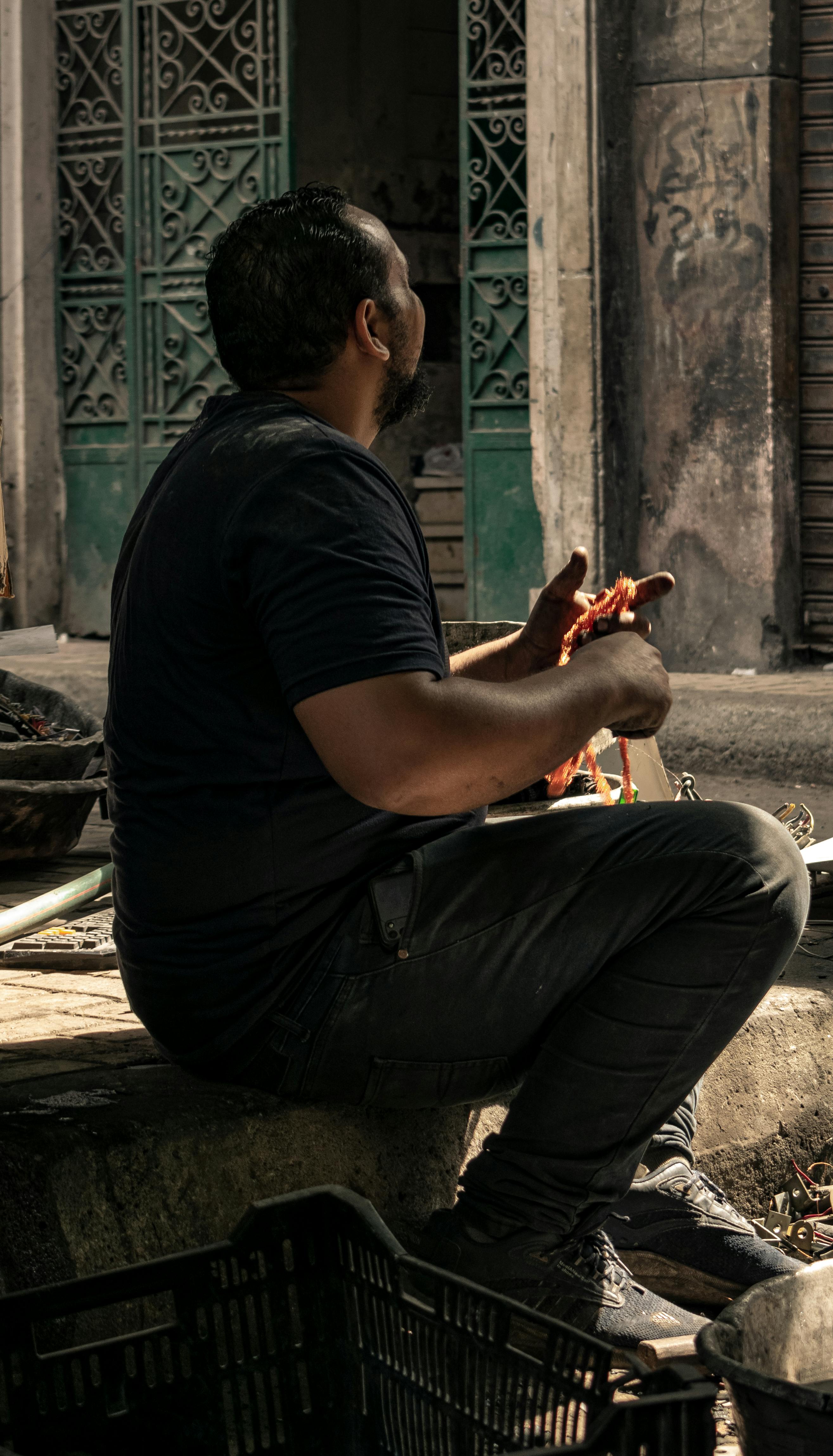 a man sitting on a bench with a cell phone