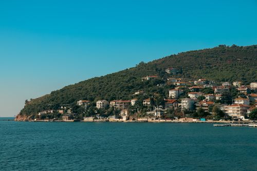 Free Beautiful summer view of the Istanbul Princely Islands coast, showcasing the serene seashore and hillside architecture. Stock Photo