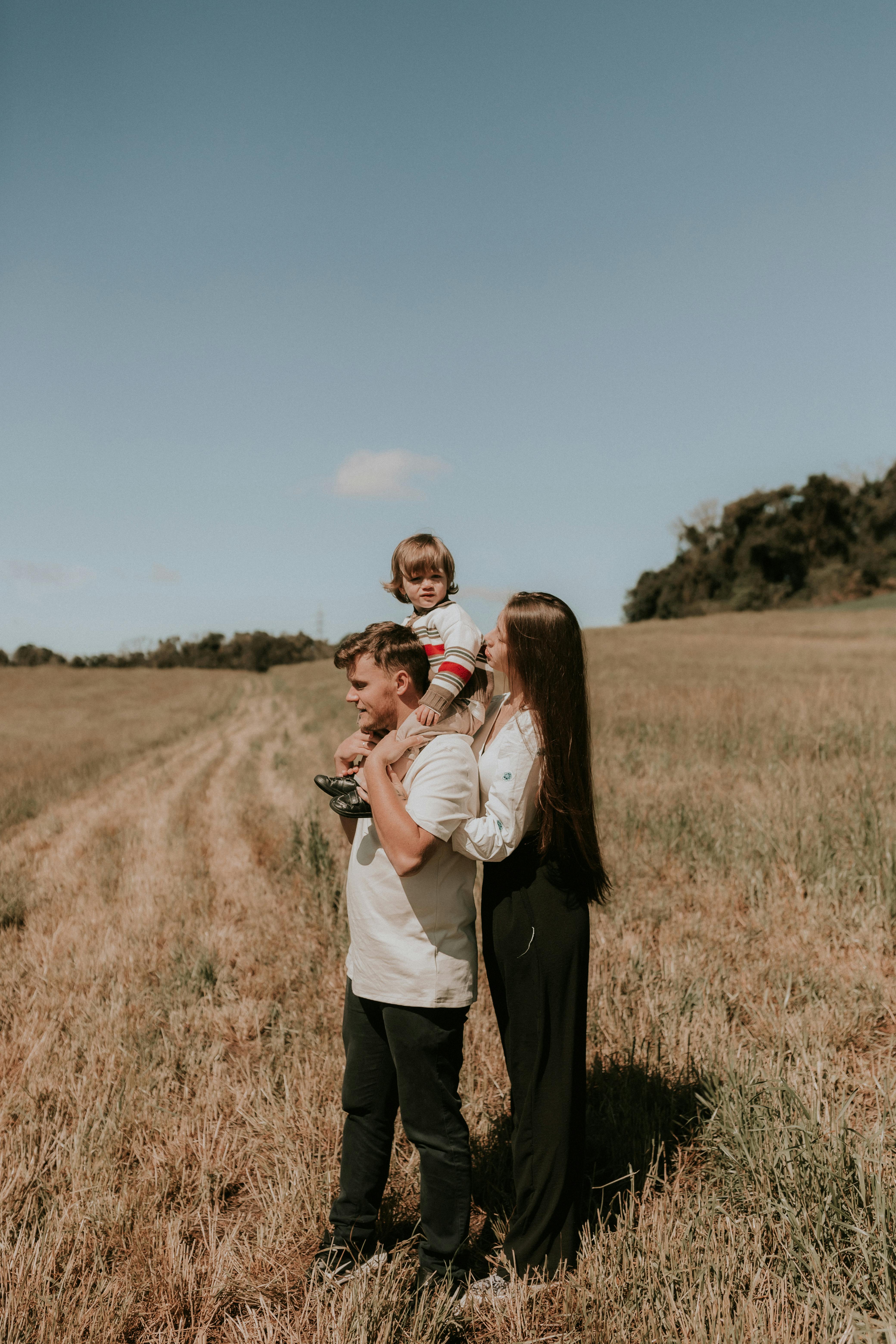 Photo of Man and Woman Playing With Their Child · Free Stock Photo