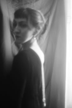 A moody black and white portrait of a woman showcasing vintage aesthetics.