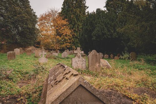 Free Ancient cemetery with historic tombstones in a lush autumn landscape in England. Stock Photo