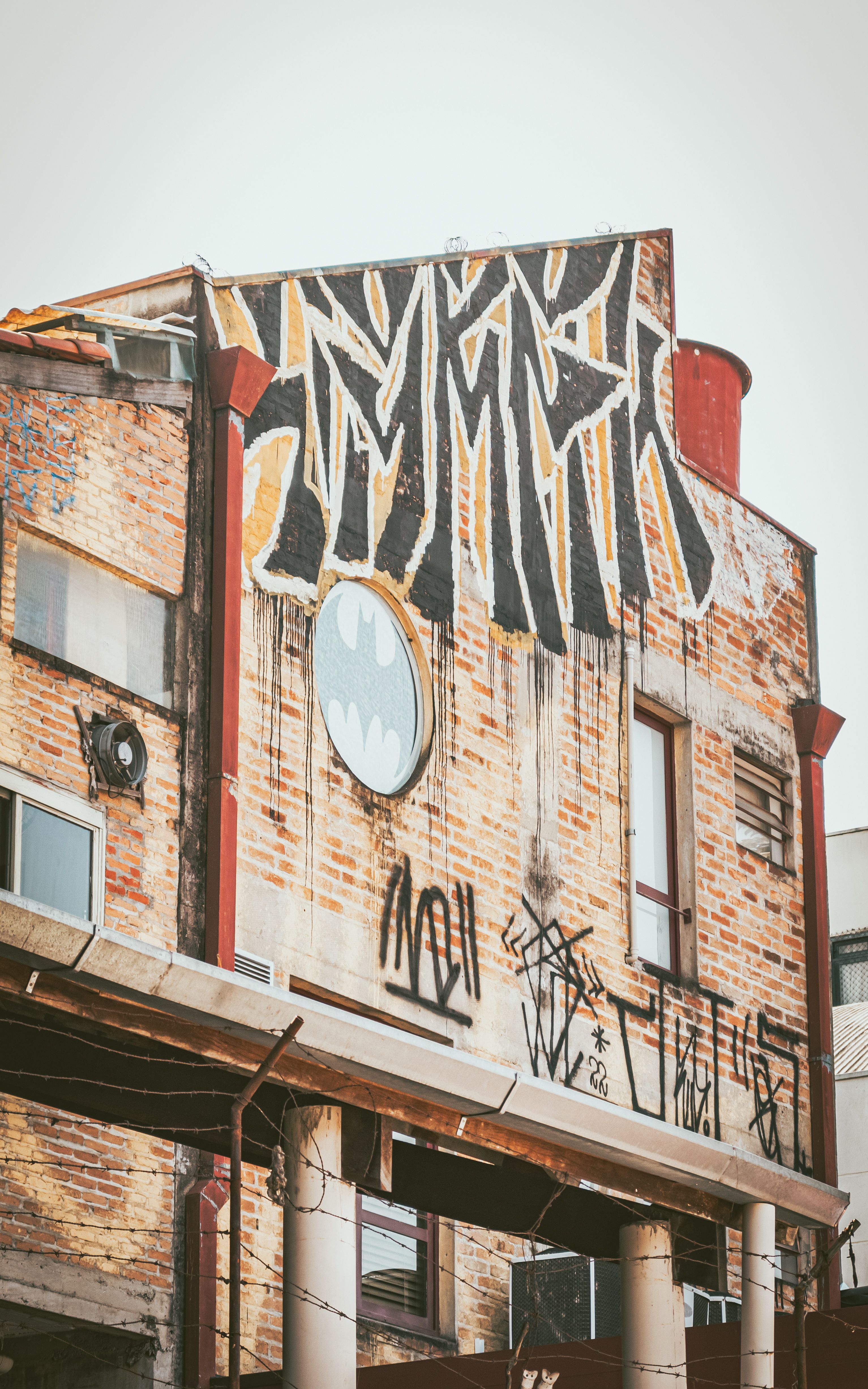 Colorful graffiti on a vintage brick building facade in São Paulo, Brazil.
