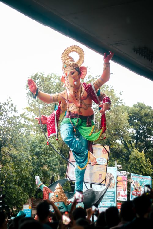 Free Vibrant outdoor Ganesha festival with idol procession and festive crowd. Stock Photo