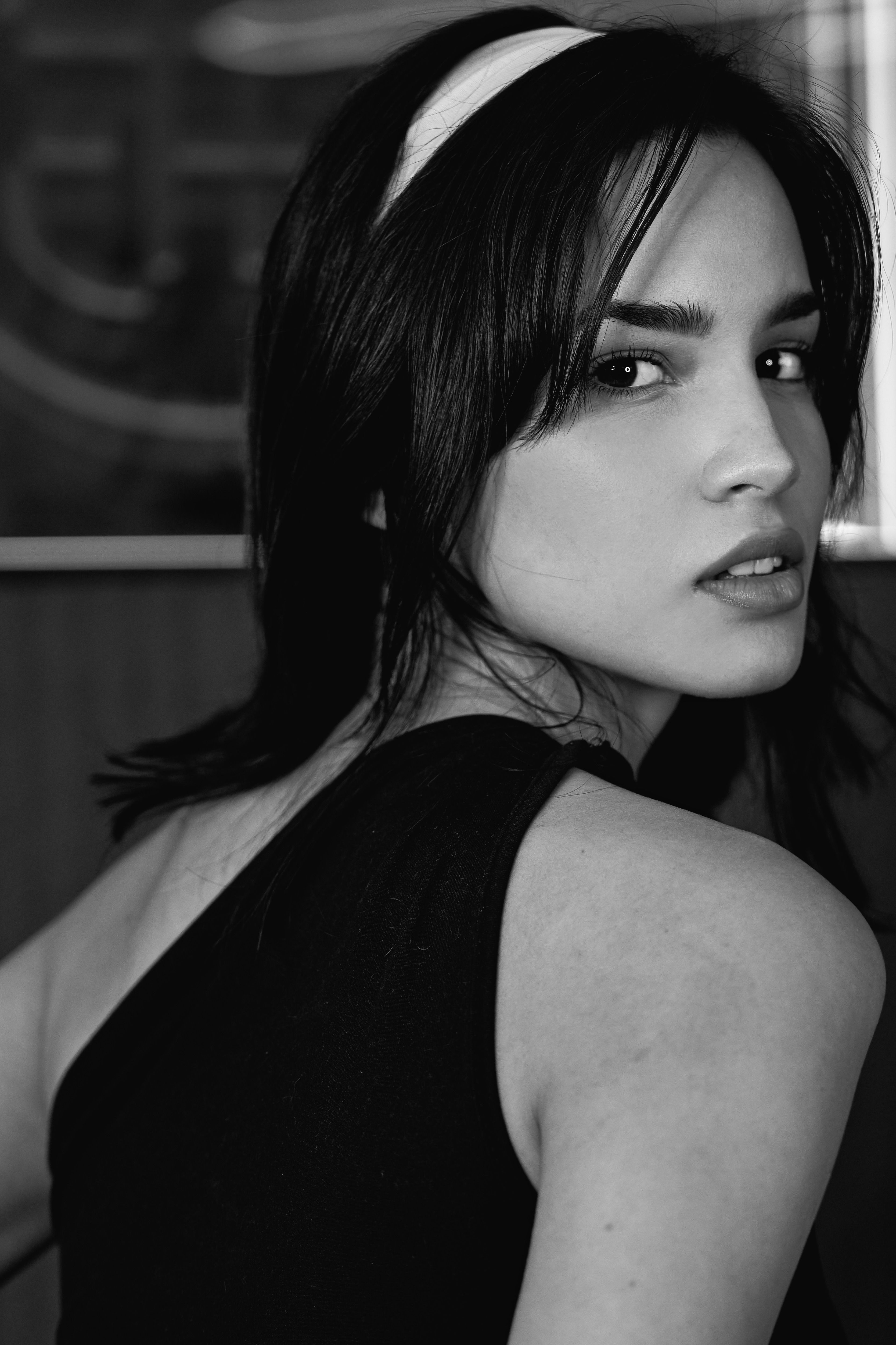 Stylish black and white portrait capturing a woman's expressive gaze.