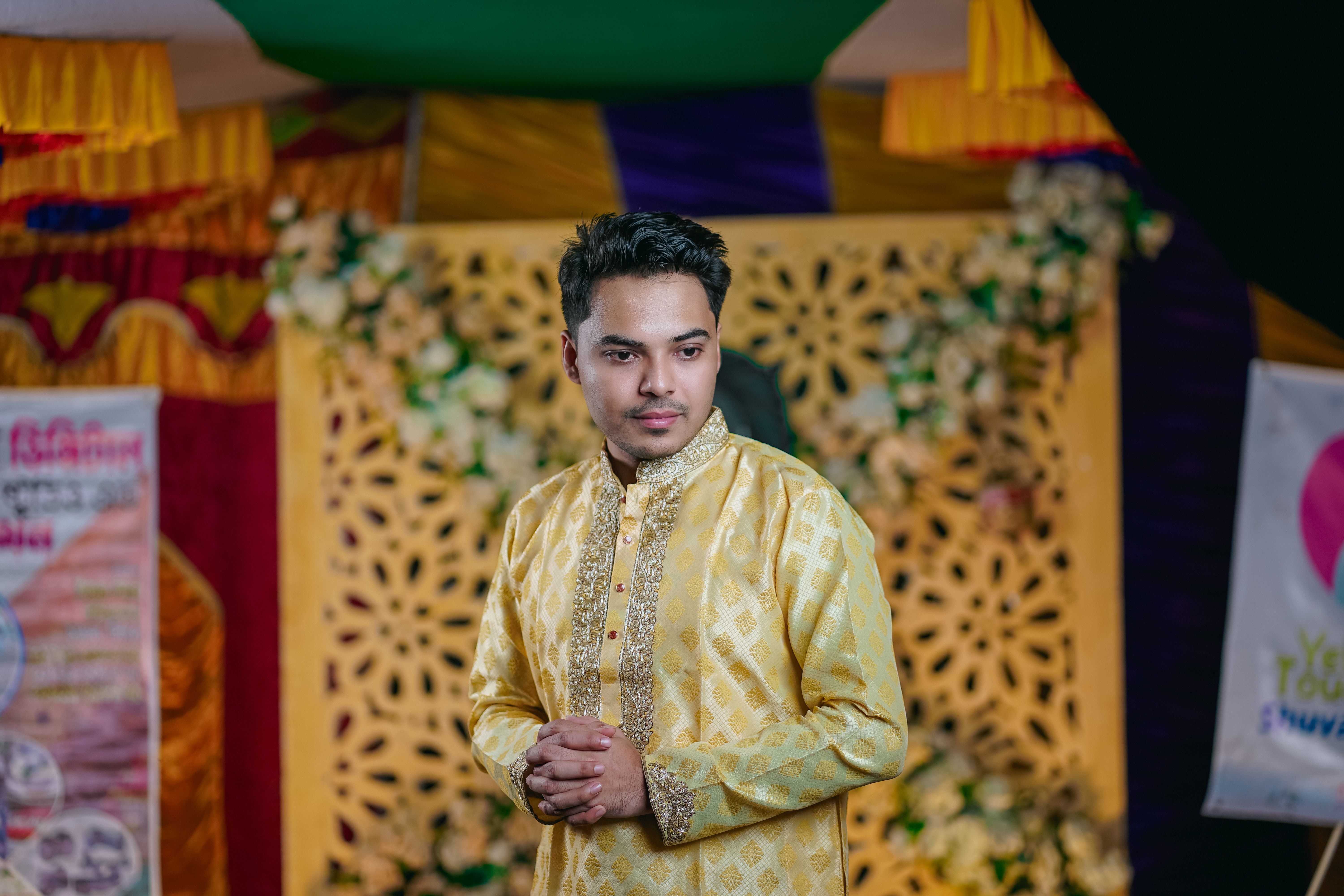 A man in yellow and gold attire standing in front of a stage · Free ...