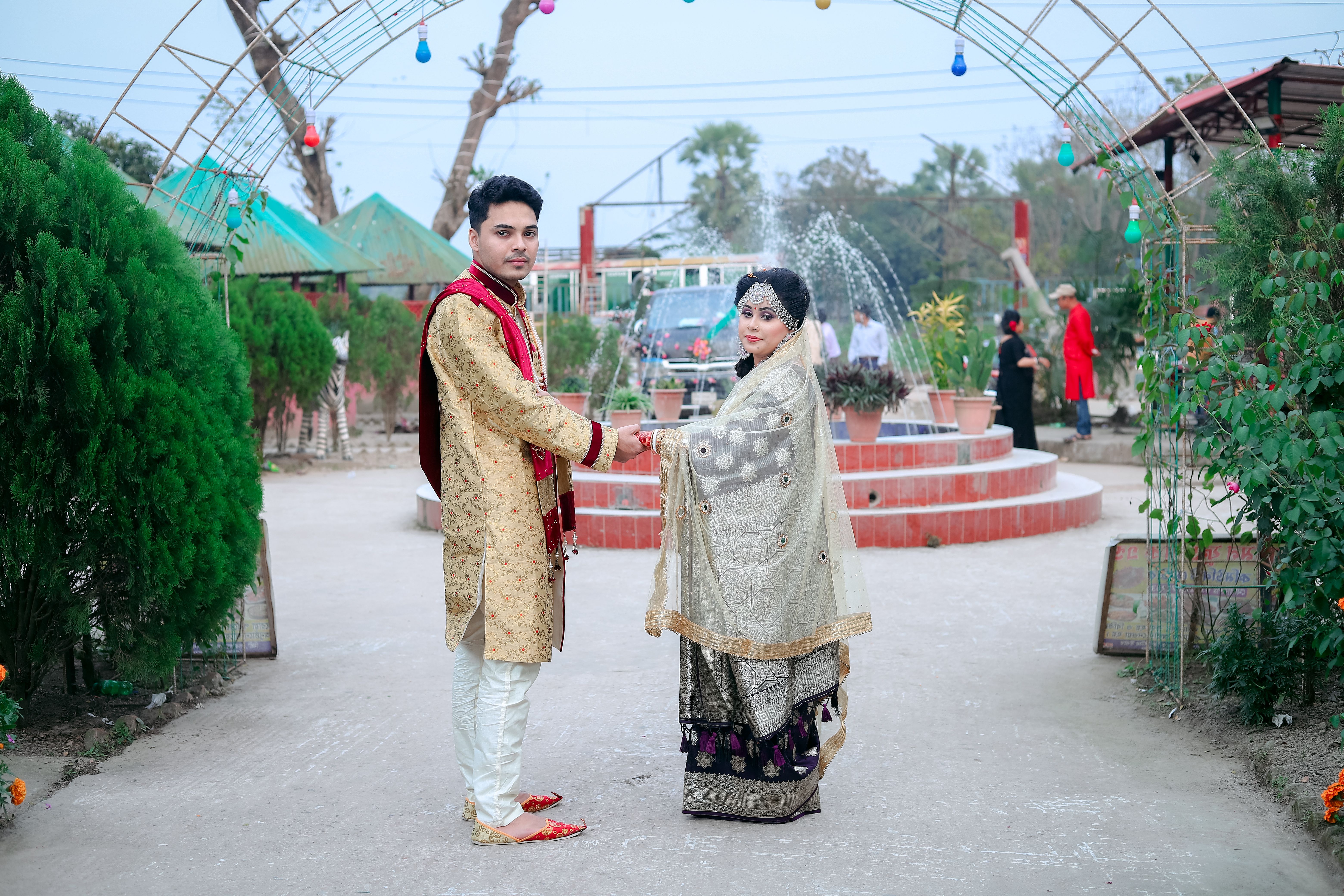 A beautiful outdoor wedding ceremony in Cumilla, Bangladesh, showcasing traditional attire.