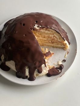 Indulge in this homemade chocolate-covered layered cake, perfect for dessert lovers.