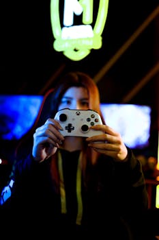 Person immersed in a gaming session holding a controller in a vivid, neon-lit room.