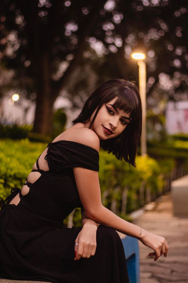 Woman in a black dress outdoors at twilight