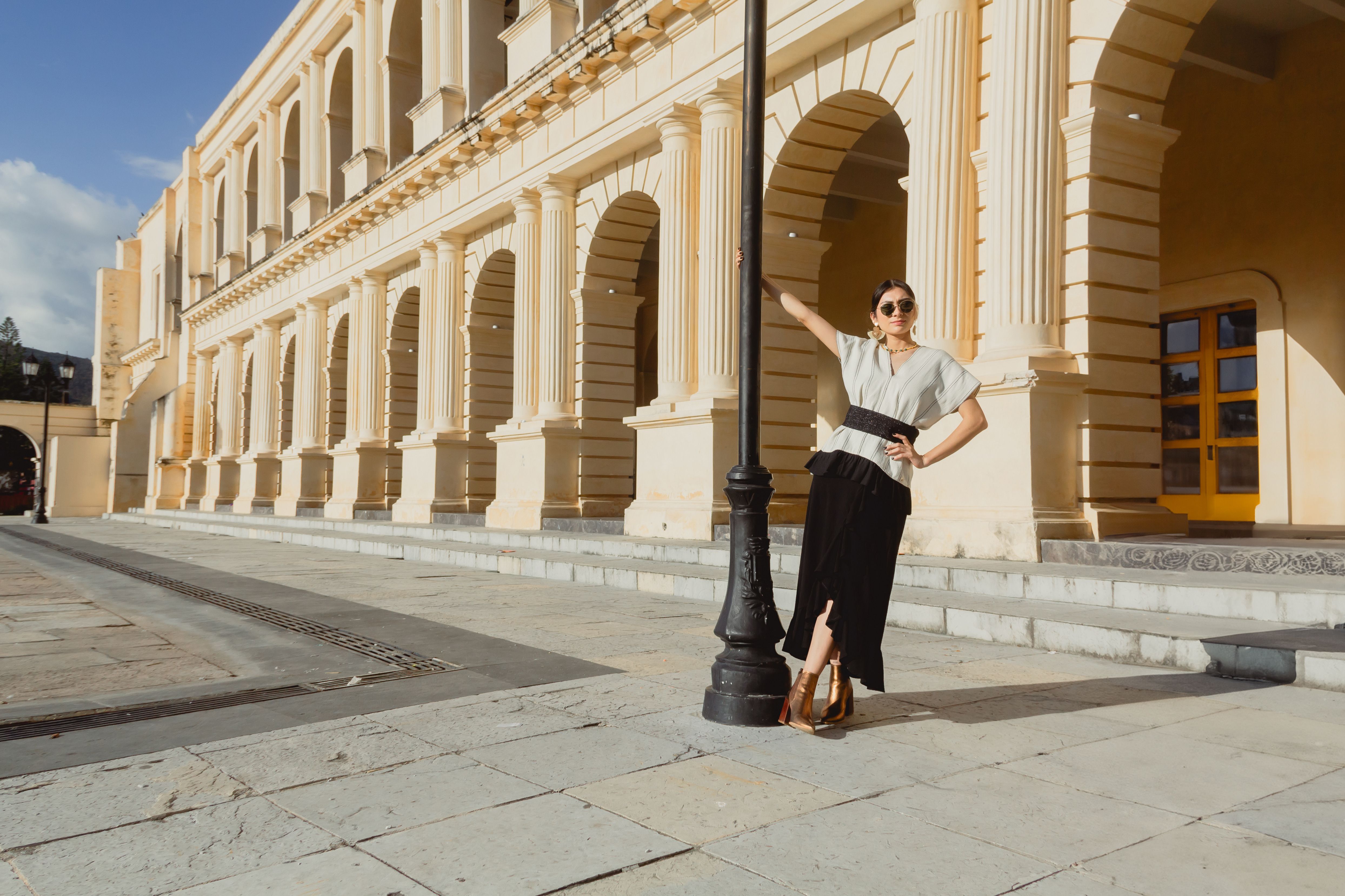 A woman is standing on a street corner · Free Stock Photo