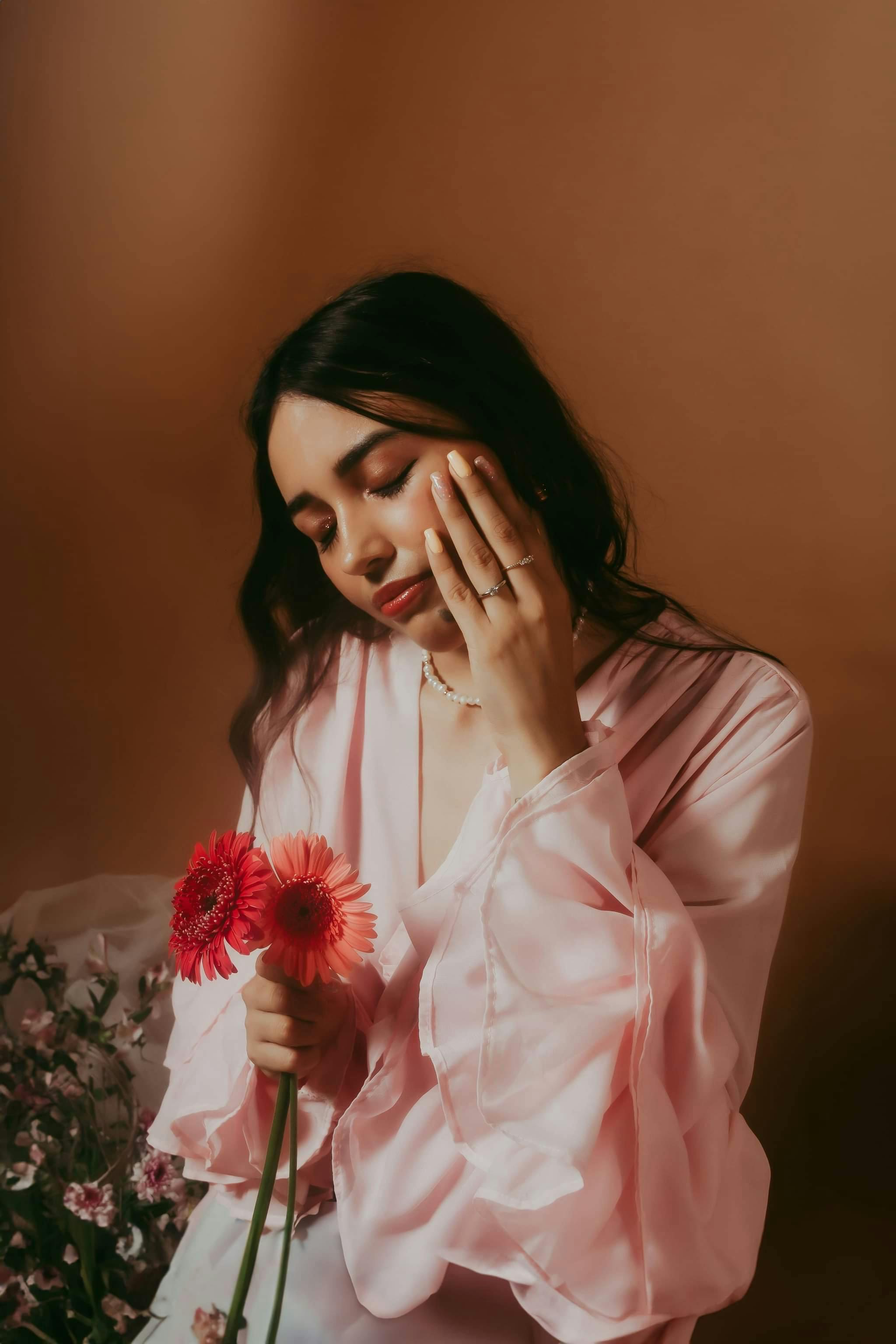 portrait of woman in pink shirt and with flowers