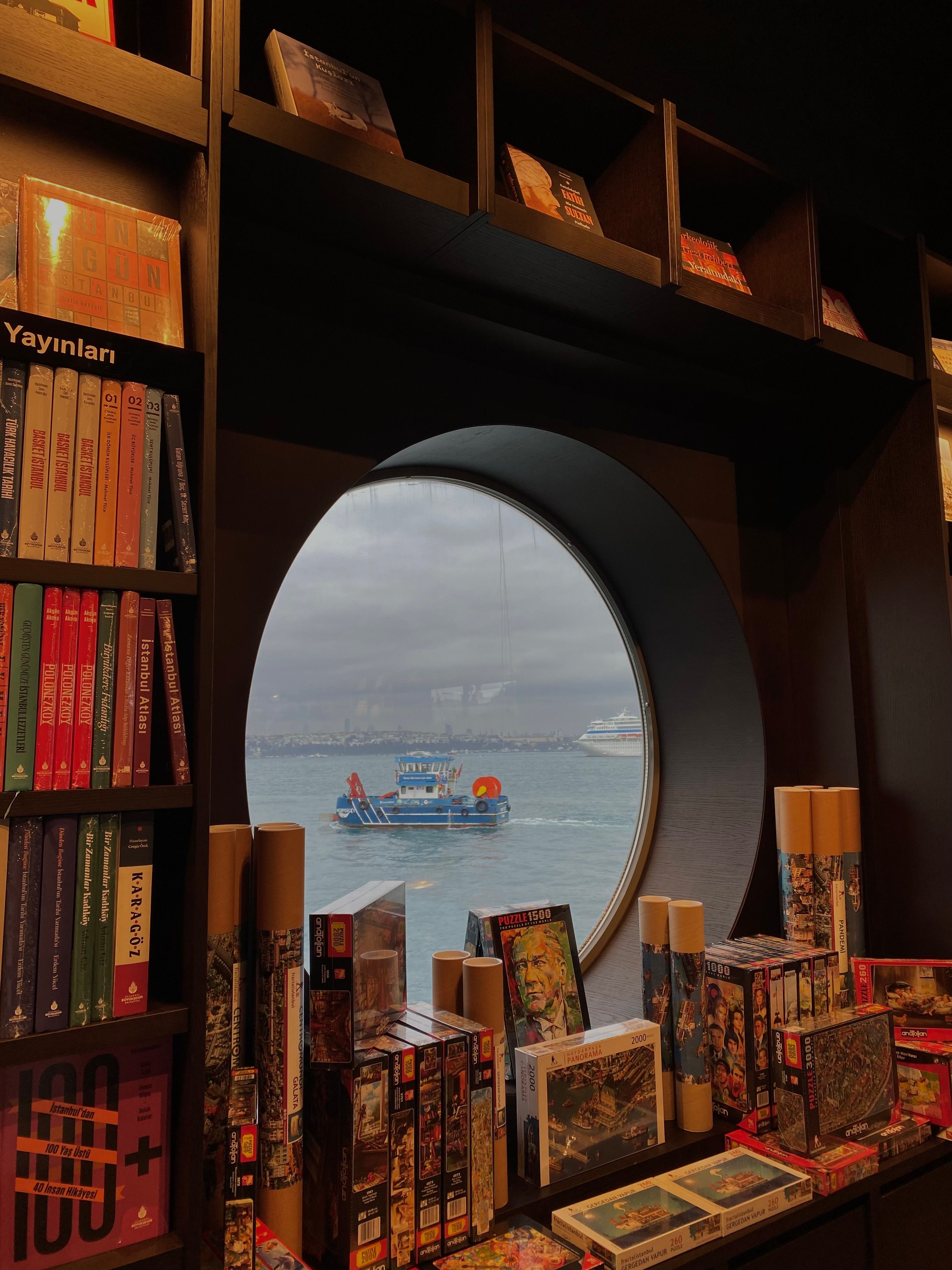A book store with a window looking out to the ocean · Free Stock Photo