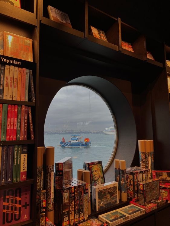 A book store with a window looking out to the ocean · Free Stock Photo