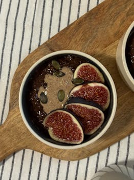 Delicious fig breakfast bowl on a wooden board, perfect for a healthy start.