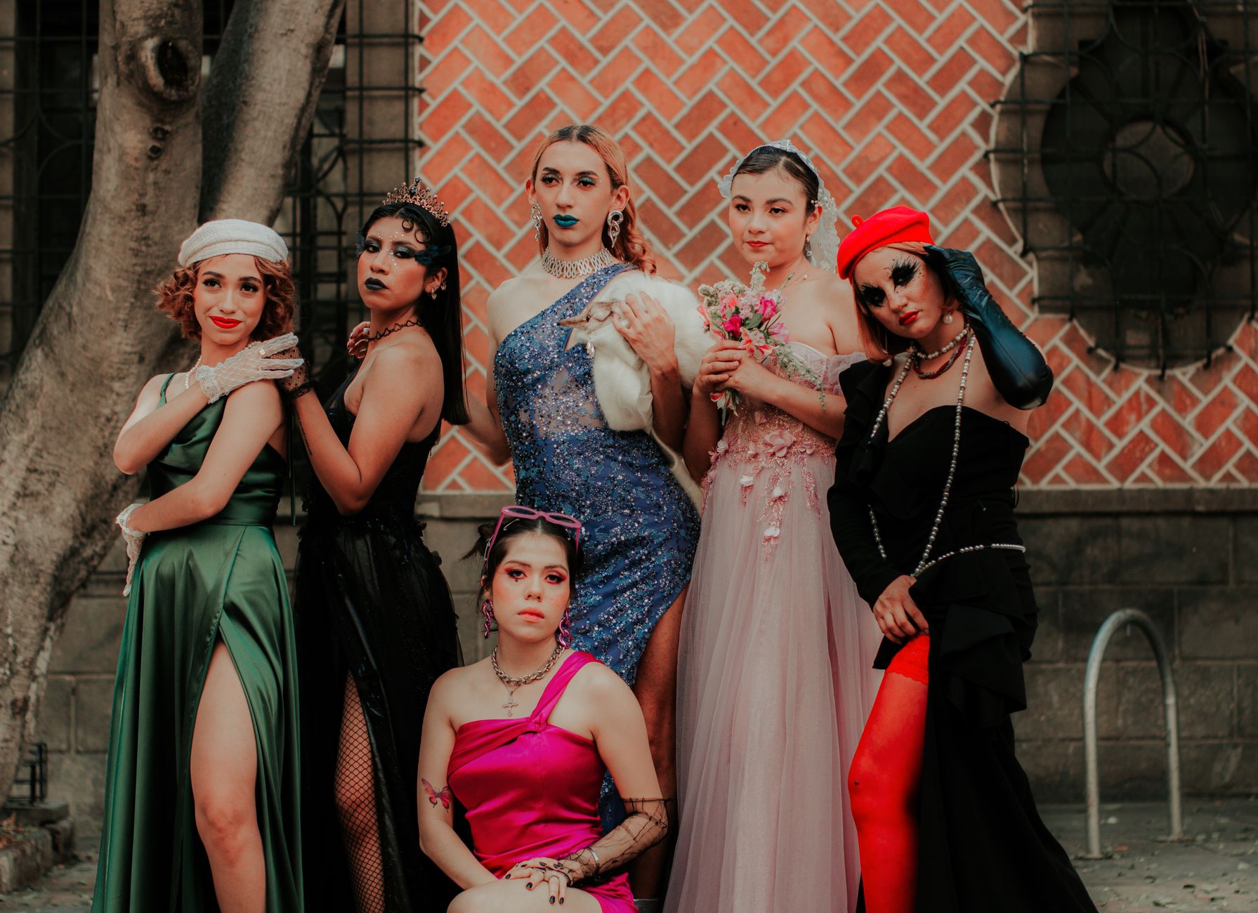 A vibrant group portrait of adults in themed costumes at an outdoor event.