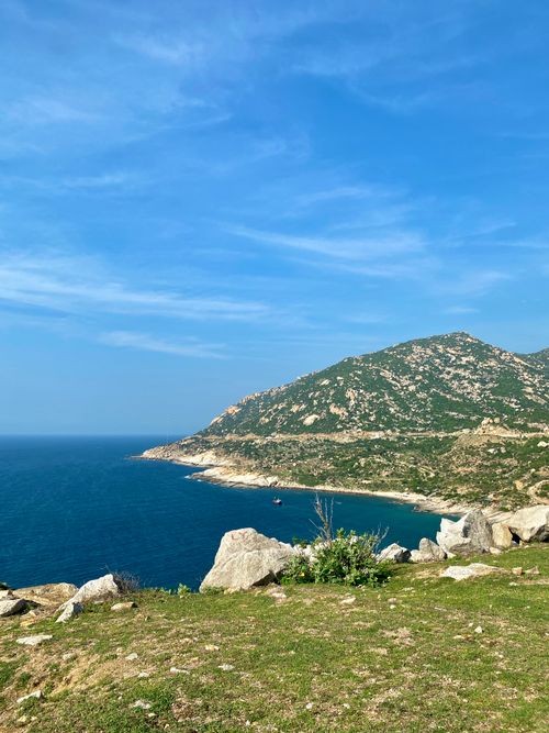 Free Beautiful coastal landscape with turquoise sea and rocky cliffs in Ninh Thuận, Vietnam under a clear blue sky. Stock Photo