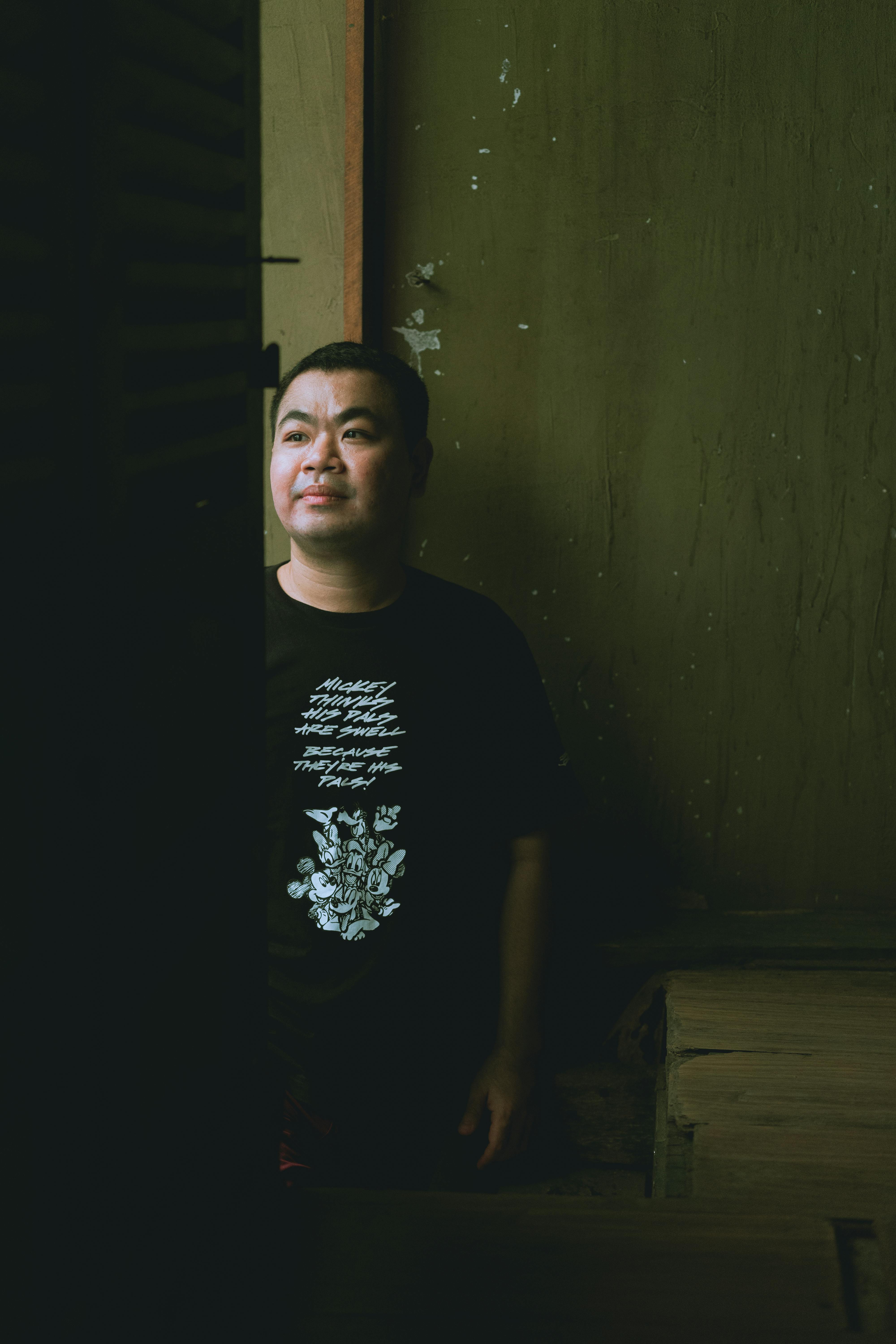 a man in a black shirt standing in a doorway