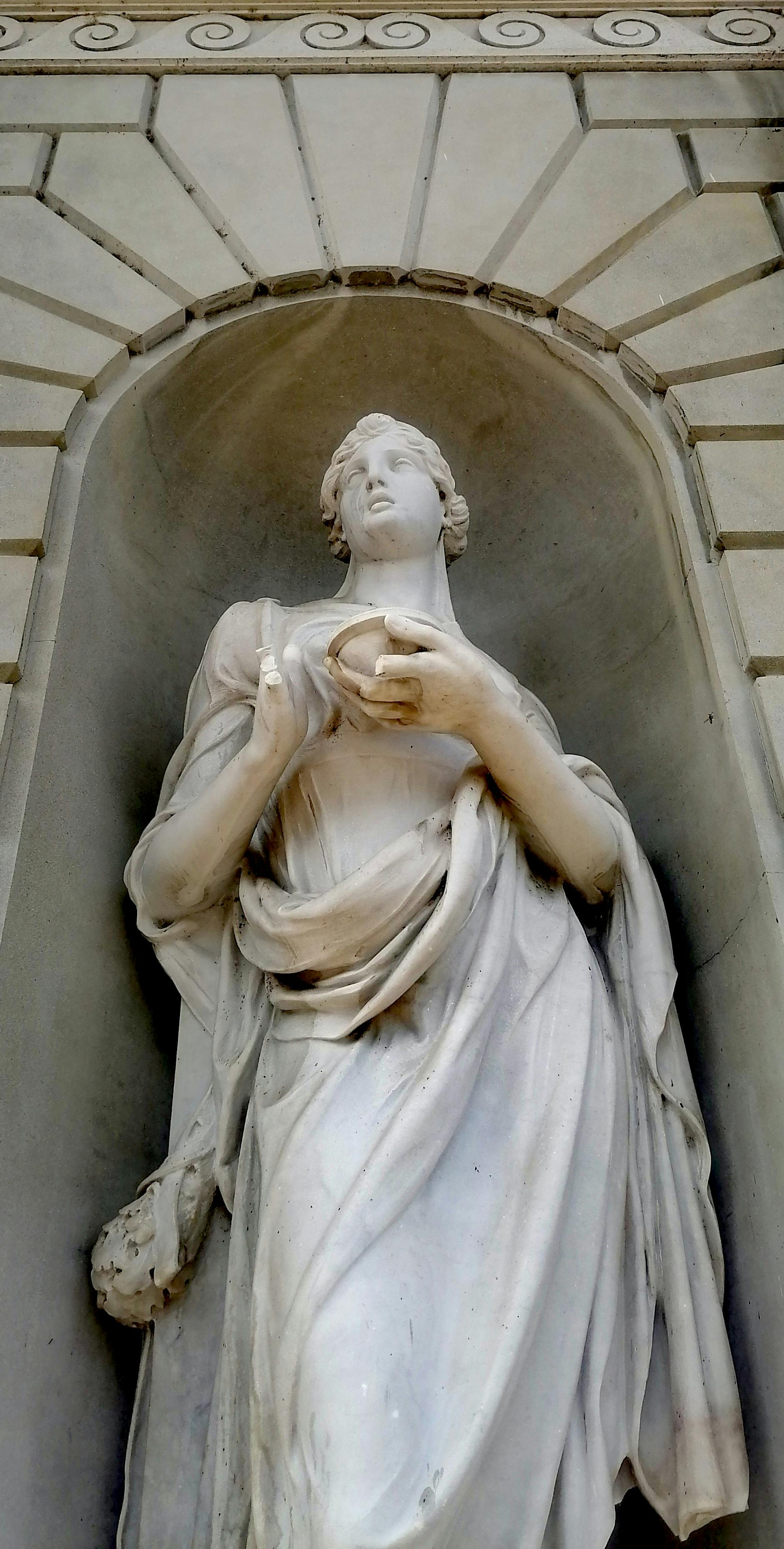 Elegant marble statue in Baroque style depicting a draped figure in Como, Italy.
