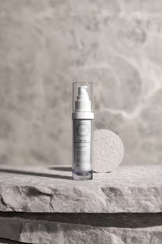 Elegant close-up of a skincare bottle against a textured stone background.