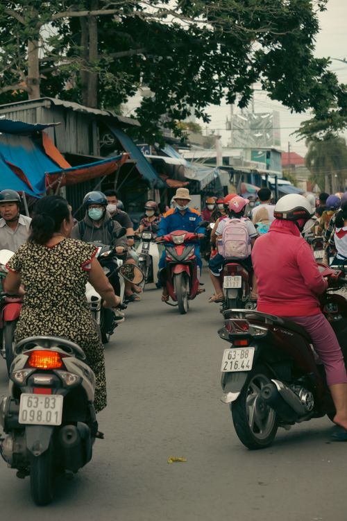 Free Crowded Vietnamese street scene with motorcyclists navigating through traffic. Stock Photo