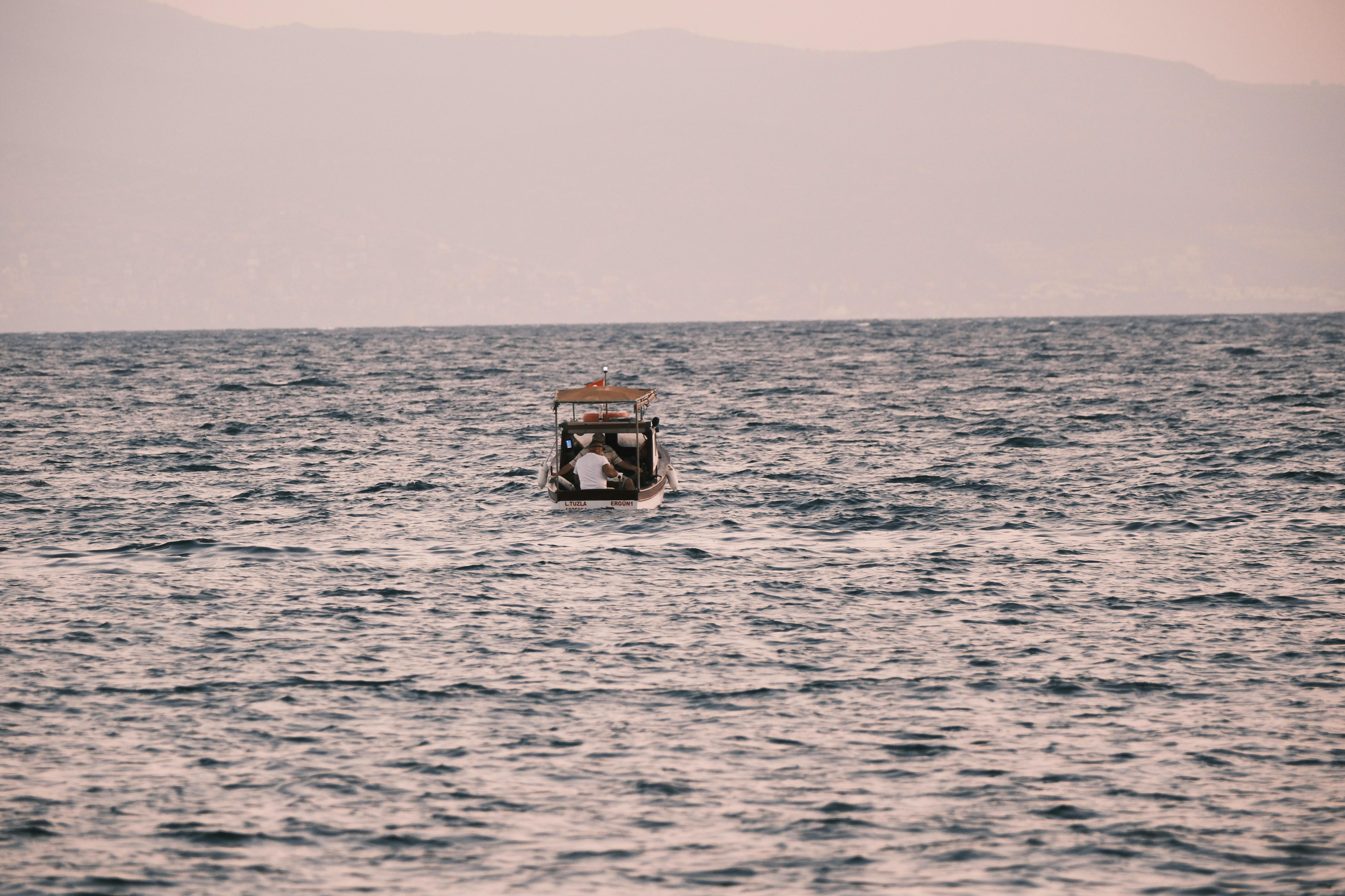 a boat in the ocean with a person on it